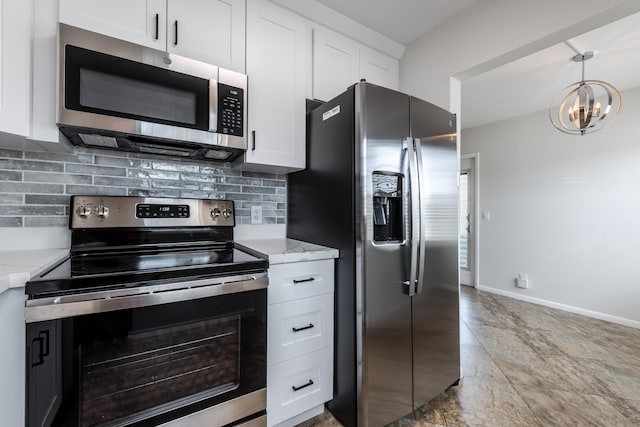 kitchen featuring a chandelier, light stone counters, tasteful backsplash, white cabinetry, and stainless steel appliances