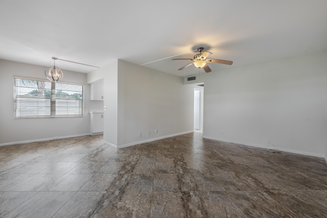 spare room featuring ceiling fan with notable chandelier and hardwood / wood-style flooring