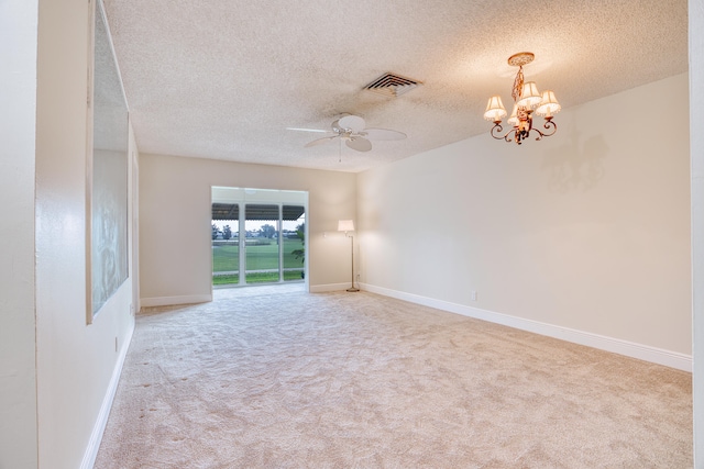 empty room featuring a textured ceiling, light colored carpet, and ceiling fan with notable chandelier