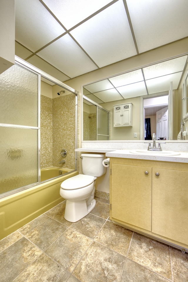 full bathroom with bath / shower combo with glass door, vanity, and toilet