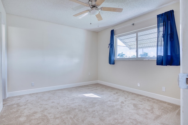 unfurnished room with a textured ceiling, light carpet, and ceiling fan