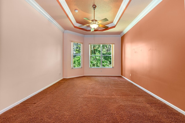 spare room featuring carpet flooring, a tray ceiling, a ceiling fan, ornamental molding, and a textured ceiling