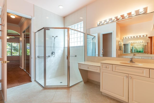 full bath with tile patterned floors, a ceiling fan, a shower stall, and vanity
