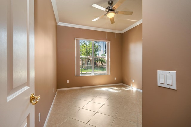 spare room with light tile patterned floors, ornamental molding, and ceiling fan