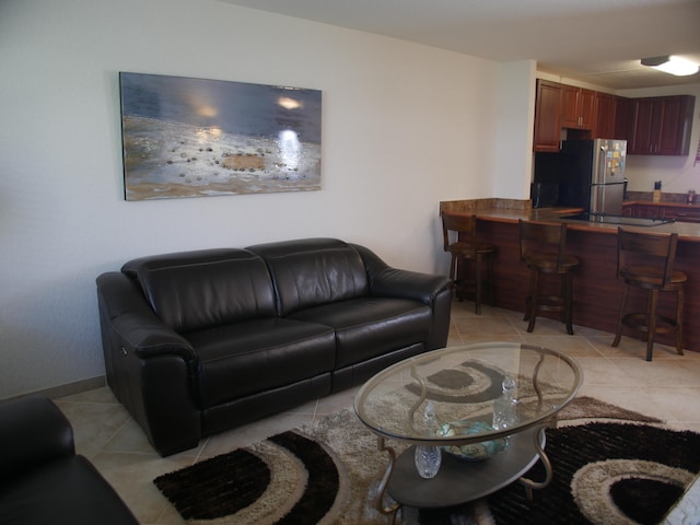 living room featuring light tile patterned flooring and indoor bar