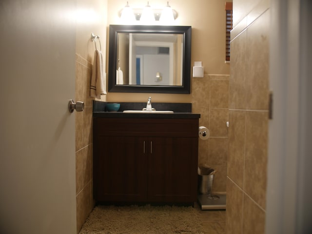 bathroom featuring tile walls and vanity