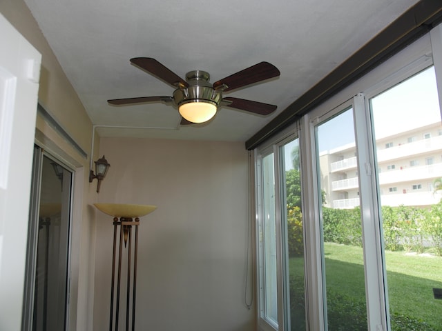 doorway with ceiling fan