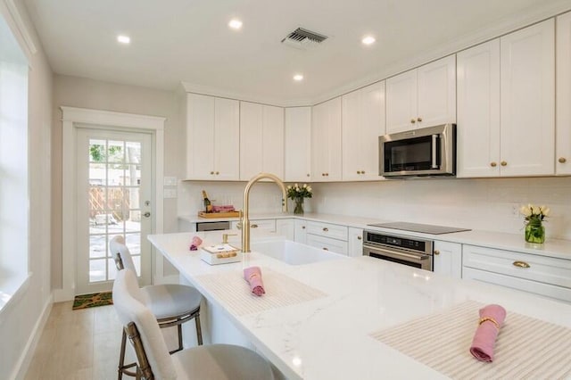 kitchen featuring white cabinets, sink, and stainless steel appliances