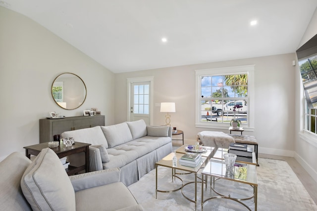 living room featuring vaulted ceiling and a wealth of natural light