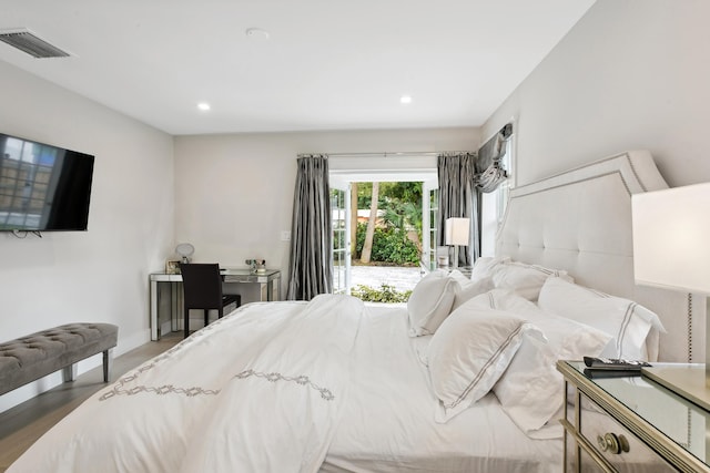 bedroom with hardwood / wood-style flooring and access to outside