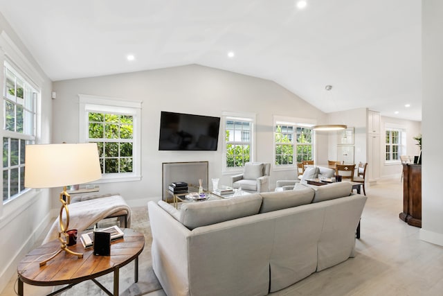 living room featuring lofted ceiling and a healthy amount of sunlight