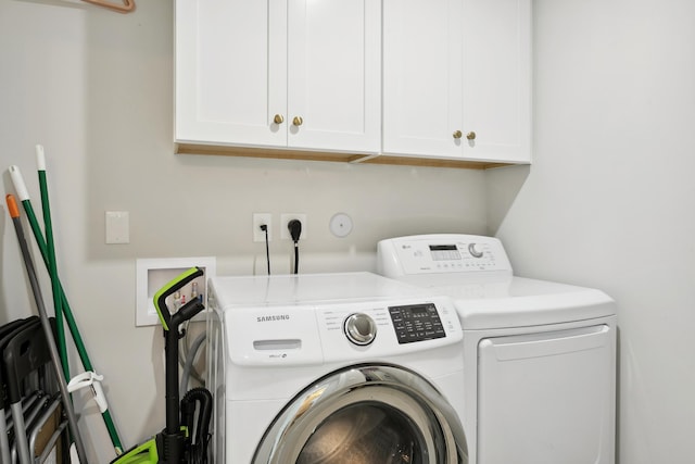 laundry area featuring cabinets and washing machine and dryer