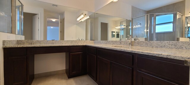 bathroom with vanity, walk in shower, and tile patterned floors