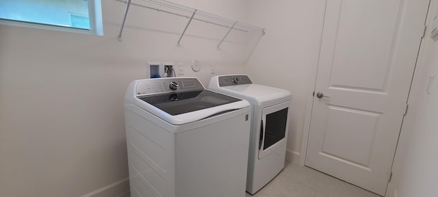 clothes washing area with washer and clothes dryer