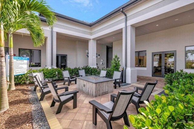 view of patio featuring an outdoor fire pit and french doors