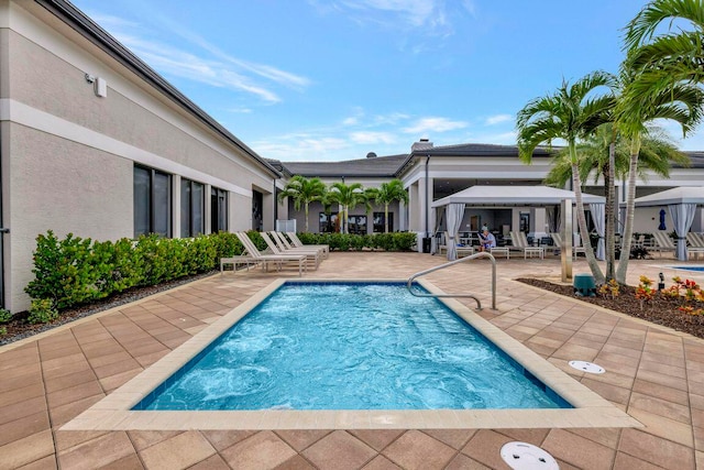 view of swimming pool with a patio and a gazebo