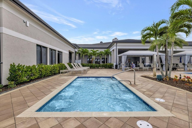 pool with a gazebo and a patio
