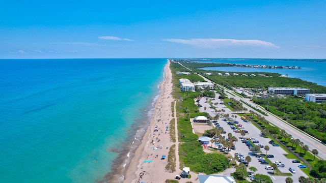 aerial view with a water view and a view of the beach