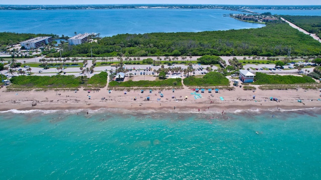 birds eye view of property featuring a beach view and a water view