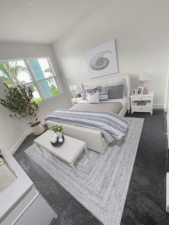 carpeted bedroom with lofted ceiling