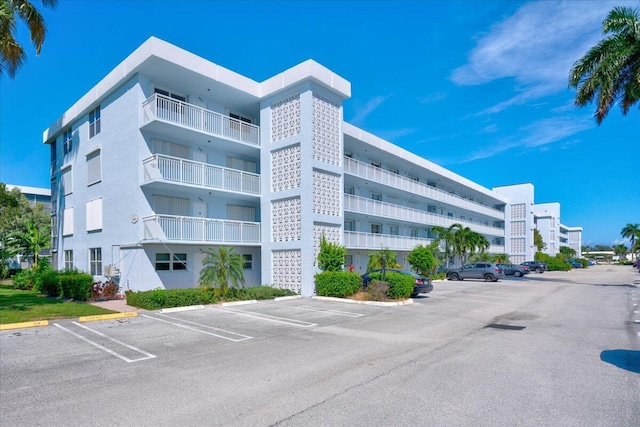 view of building exterior featuring uncovered parking