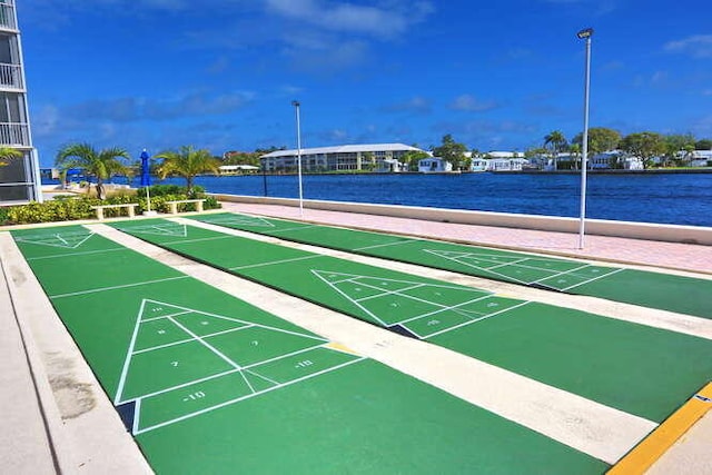 view of community with a water view and shuffleboard