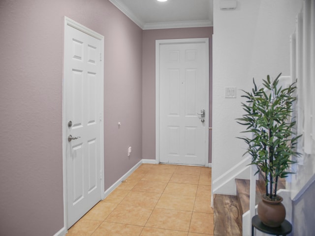 doorway with crown molding and light tile patterned floors