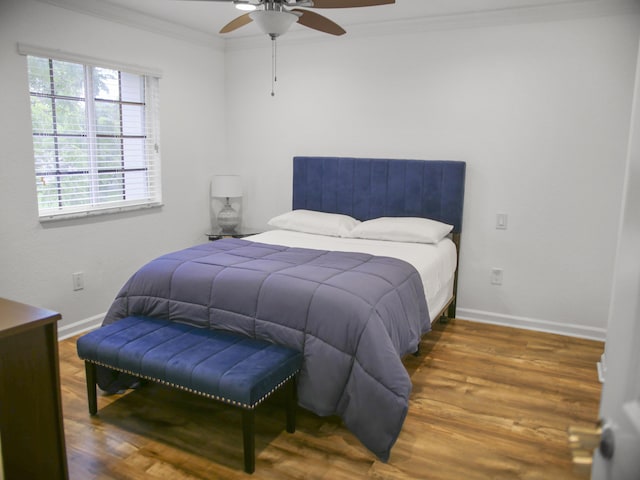 bedroom featuring crown molding, ceiling fan, and hardwood / wood-style floors