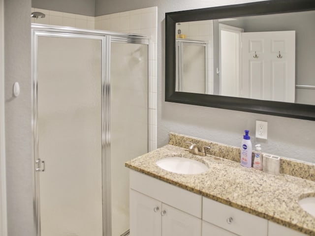 bathroom with vanity and an enclosed shower