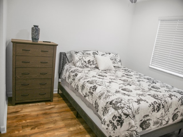 bedroom with ceiling fan and dark hardwood / wood-style flooring