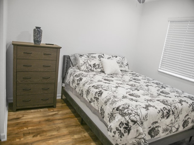 bedroom with dark wood-type flooring