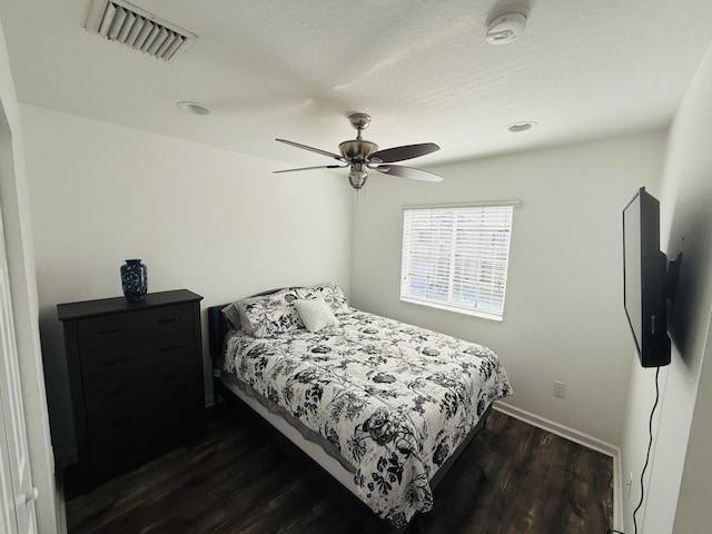 bedroom featuring ceiling fan and dark hardwood / wood-style flooring