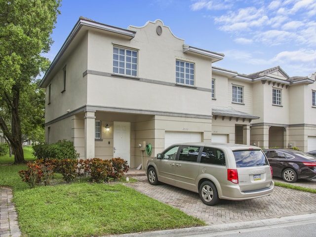 townhome / multi-family property featuring a garage