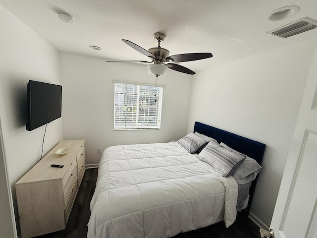 bedroom featuring ceiling fan and dark hardwood / wood-style flooring