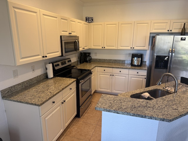 kitchen featuring stainless steel appliances, sink, white cabinets, and stone counters