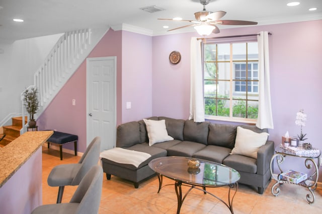 living room featuring ceiling fan, light tile patterned flooring, plenty of natural light, and crown molding