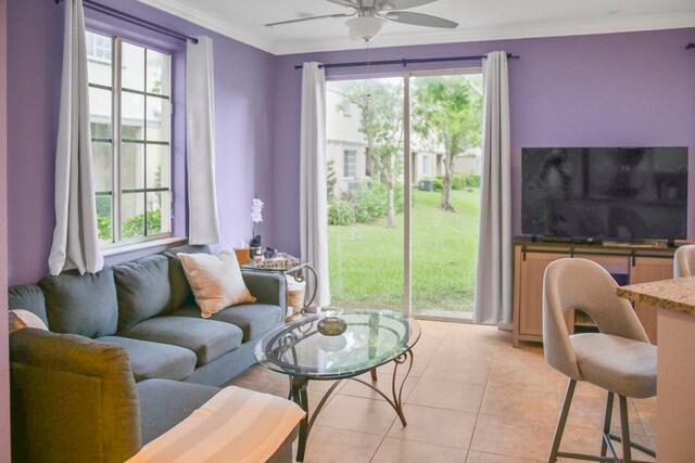 tiled living room with ornamental molding and ceiling fan