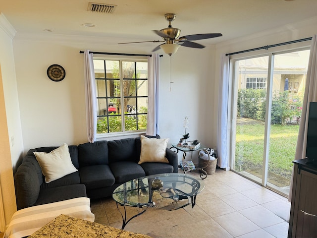 tiled living room featuring crown molding and ceiling fan