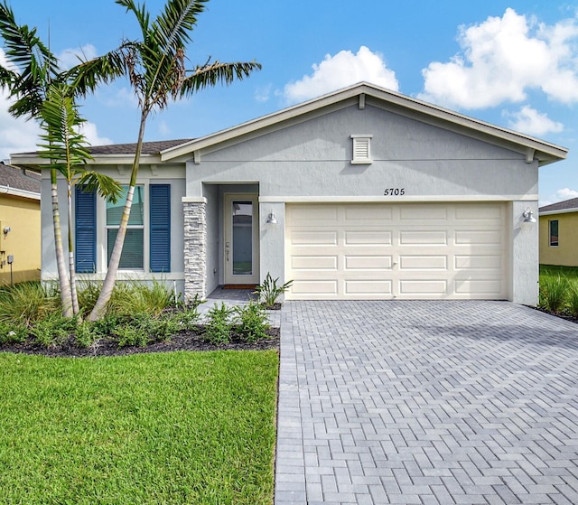 ranch-style house with a garage and a front lawn