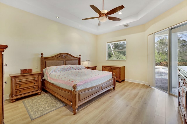 bedroom with access to outside, multiple windows, ceiling fan, and light hardwood / wood-style flooring