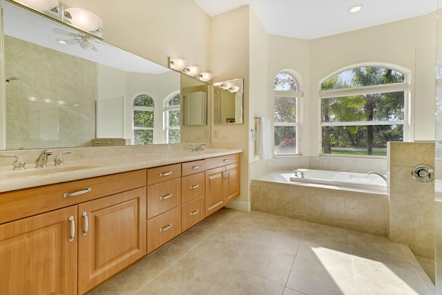 bathroom featuring tile patterned flooring, vanity, a relaxing tiled tub, and ceiling fan