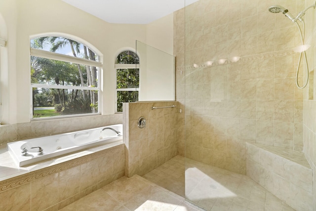 bathroom with tile patterned floors and shower with separate bathtub