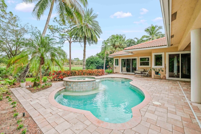 view of swimming pool featuring an in ground hot tub and a patio