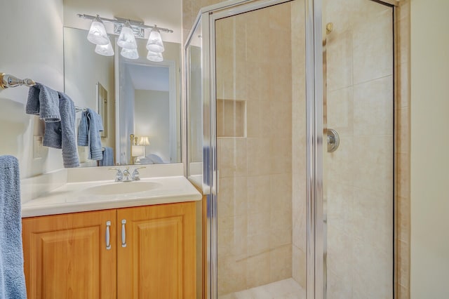 bathroom with a shower with door and vanity