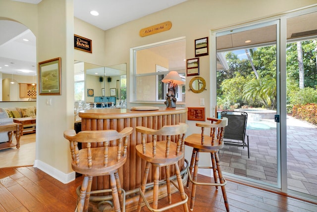 bar with hardwood / wood-style flooring