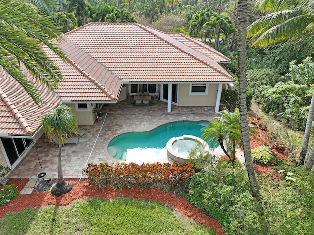 view of swimming pool featuring an in ground hot tub, a patio, and an outdoor living space