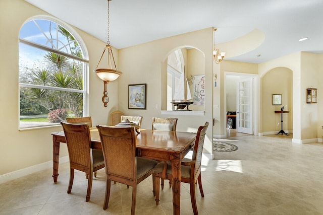 dining space with light tile patterned floors and a notable chandelier