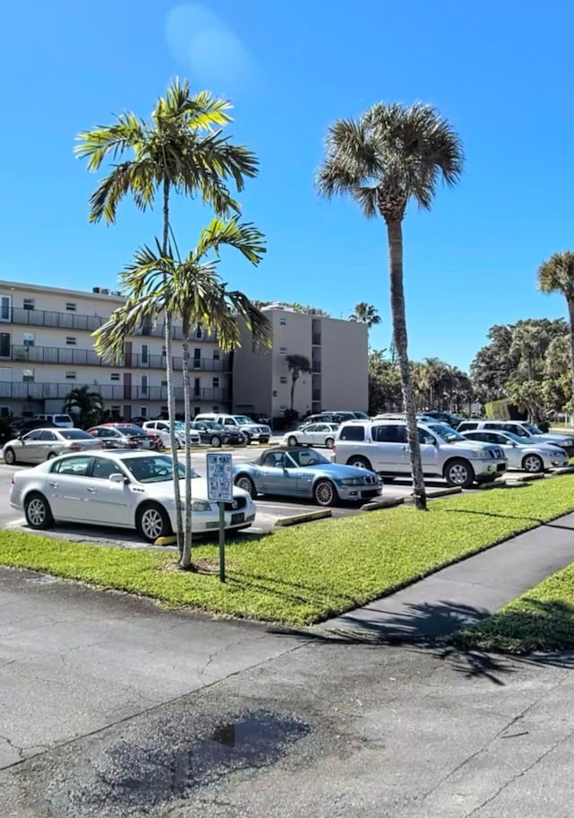 view of car parking with a yard