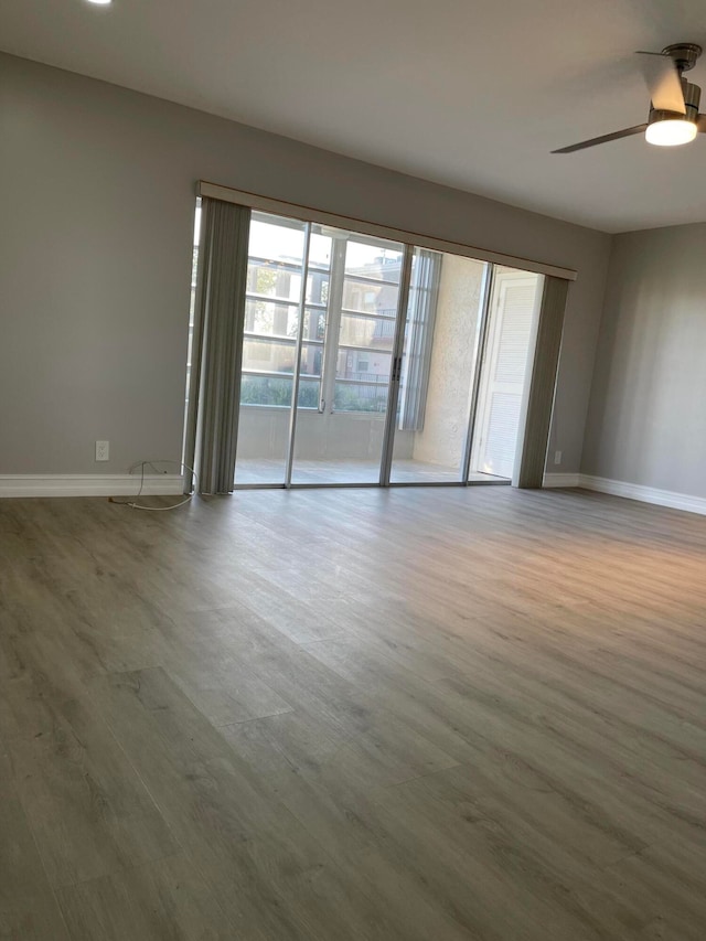 empty room featuring wood-type flooring and ceiling fan