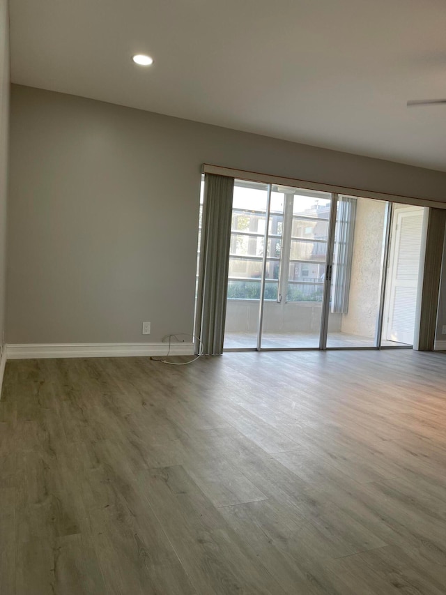 unfurnished room with wood-type flooring